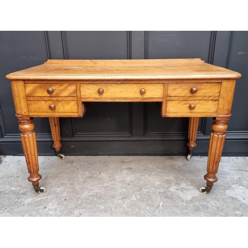 1071 - A Victorian mahogany desk, on reeded legs, 121cm wide.