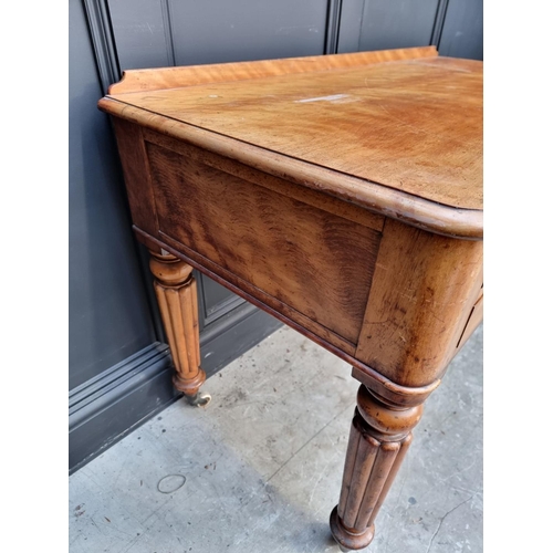 1071 - A Victorian mahogany desk, on reeded legs, 121cm wide.