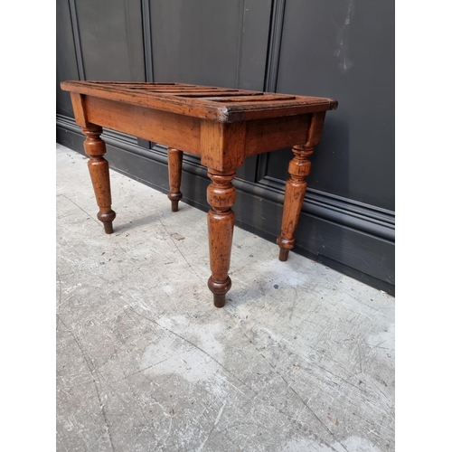 1073 - A Victorian oak luggage stand, stamped 'Gillows 2910', 60.5cm wide. 