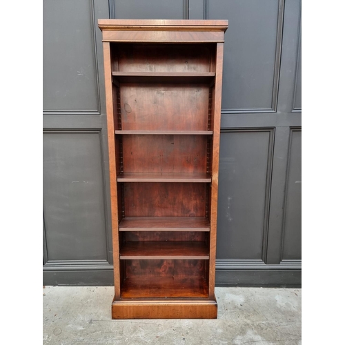 1077 - A reproduction mahogany bookcase, with five adjustable shelves, 173cm high x 67cm wide. ... 