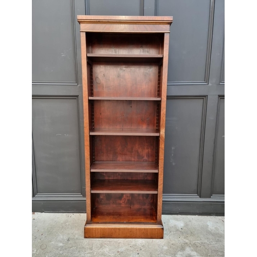 1077 - A reproduction mahogany bookcase, with five adjustable shelves, 173cm high x 67cm wide. ... 