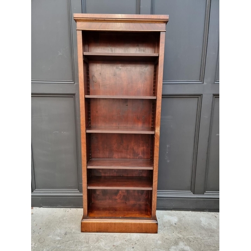 1077 - A reproduction mahogany bookcase, with five adjustable shelves, 173cm high x 67cm wide. ... 