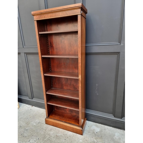 1077 - A reproduction mahogany bookcase, with five adjustable shelves, 173cm high x 67cm wide. ... 