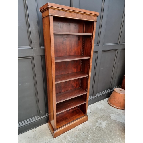 1077 - A reproduction mahogany bookcase, with five adjustable shelves, 173cm high x 67cm wide. ... 