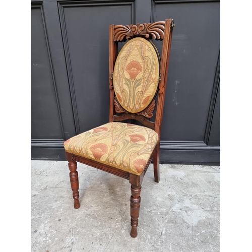 1082 - An unusual Victorian carved mahogany metamorphic chair, the folding back incorporating an oval mirro... 