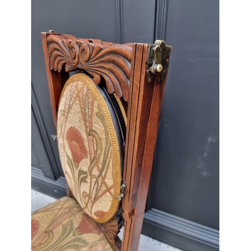 1082 - An unusual Victorian carved mahogany metamorphic chair, the folding back incorporating an oval mirro... 