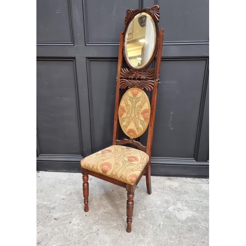 1082 - An unusual Victorian carved mahogany metamorphic chair, the folding back incorporating an oval mirro... 