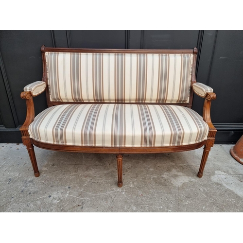 1083 - A late 19th century walnut and upholstered open arm settee, 130cm wide. 