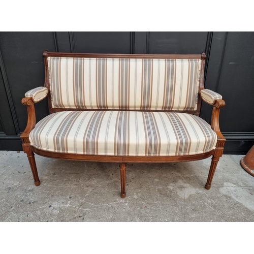 1083 - A late 19th century walnut and upholstered open arm settee, 130cm wide. 