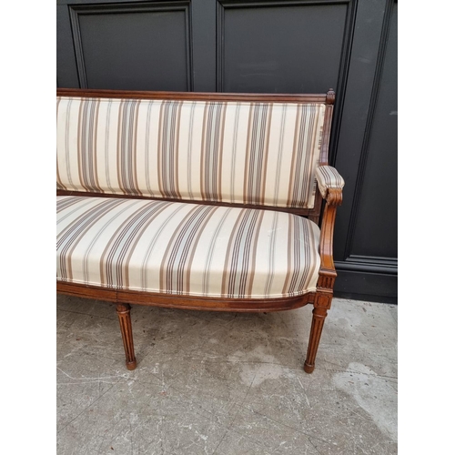 1083 - A late 19th century walnut and upholstered open arm settee, 130cm wide. 