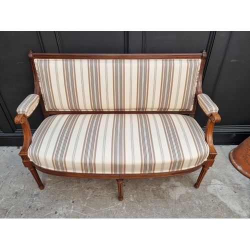 1083 - A late 19th century walnut and upholstered open arm settee, 130cm wide. 