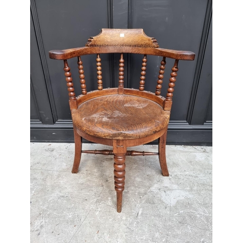 1091 - A late Victorian oak and elm smoker's bow chair, the rear seat rail N.M.