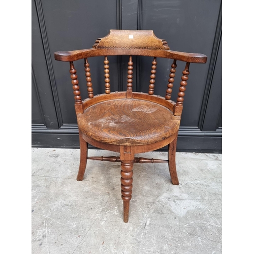 1091 - A late Victorian oak and elm smoker's bow chair, the rear seat rail N.M.