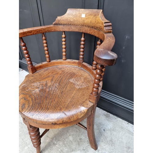 1091 - A late Victorian oak and elm smoker's bow chair, the rear seat rail N.M.