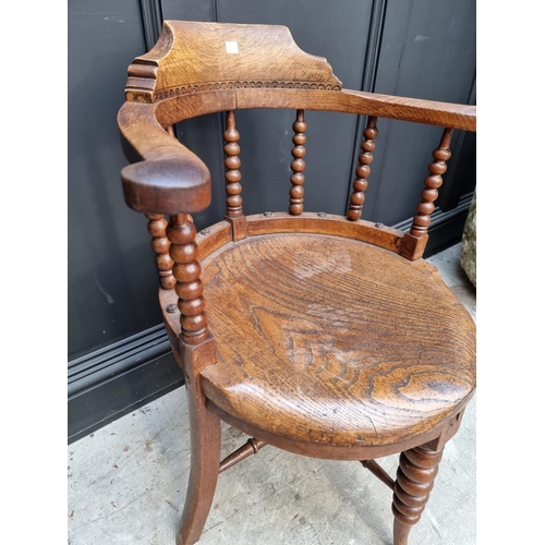 1091 - A late Victorian oak and elm smoker's bow chair, the rear seat rail N.M.