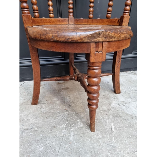 1091 - A late Victorian oak and elm smoker's bow chair, the rear seat rail N.M.