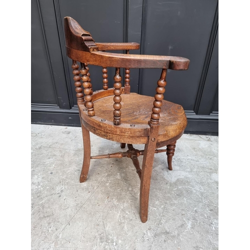 1091 - A late Victorian oak and elm smoker's bow chair, the rear seat rail N.M.