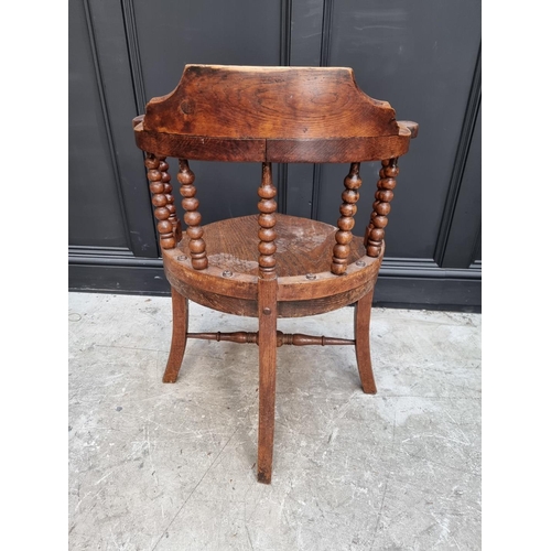 1091 - A late Victorian oak and elm smoker's bow chair, the rear seat rail N.M.