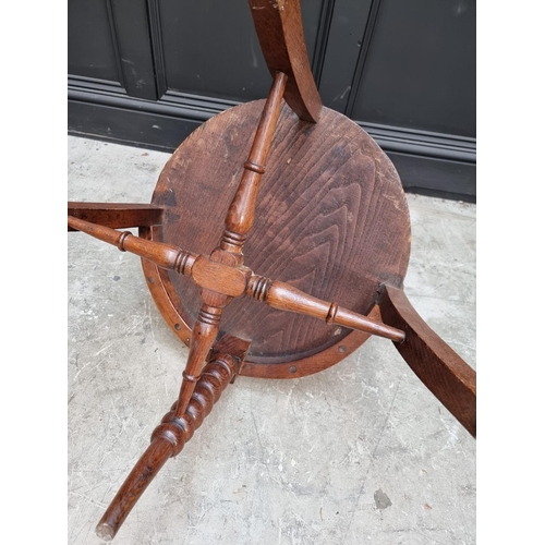 1091 - A late Victorian oak and elm smoker's bow chair, the rear seat rail N.M.