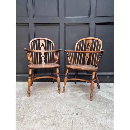 1095 - A pair of old ash, elm and fruitwood Windsor armchairs, each stamped 'CB'. 