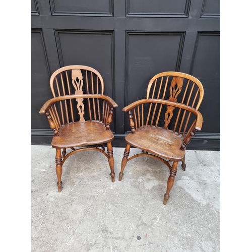 1095 - A pair of old ash, elm and fruitwood Windsor armchairs, each stamped 'CB'. 