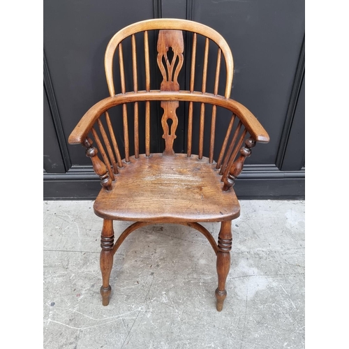 1095 - A pair of old ash, elm and fruitwood Windsor armchairs, each stamped 'CB'. 