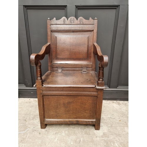 1098 - A 17th century panelled oak box seat open armchair, 106.5cm high x 60cm wide.  ... 