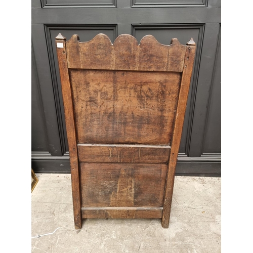 1098 - A 17th century panelled oak box seat open armchair, 106.5cm high x 60cm wide.  ... 