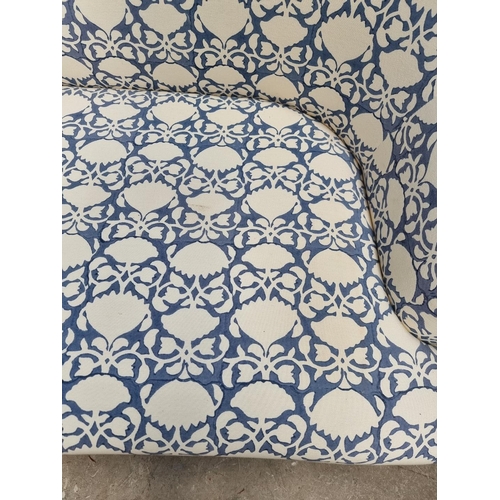 1099 - A contemporary blue and white upholstered settee, 175cm wide. 