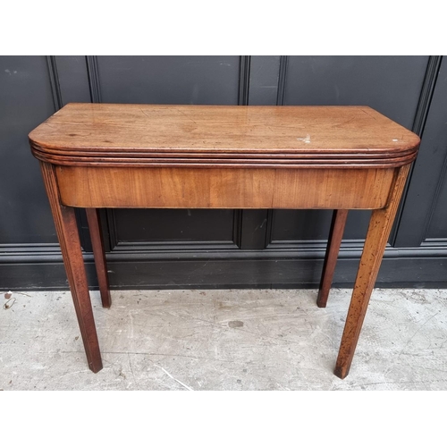 1103 - A George III mahogany tea table, with double gateleg action, 91cm wide, (s.d.).