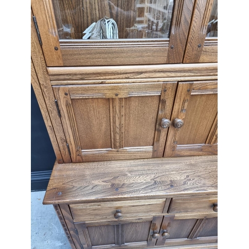 1119 - An Ercol elm bookcase, 96cm wide.