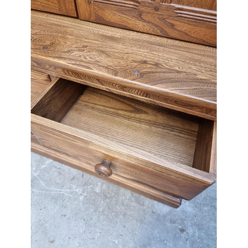 1119 - An Ercol elm bookcase, 96cm wide.