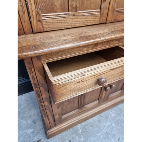 1119 - An Ercol elm bookcase, 96cm wide.