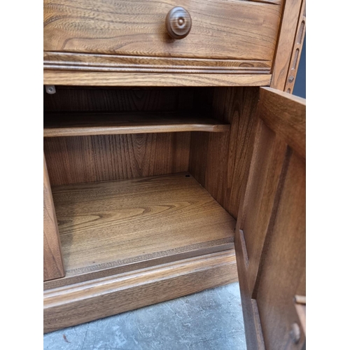 1119 - An Ercol elm bookcase, 96cm wide.