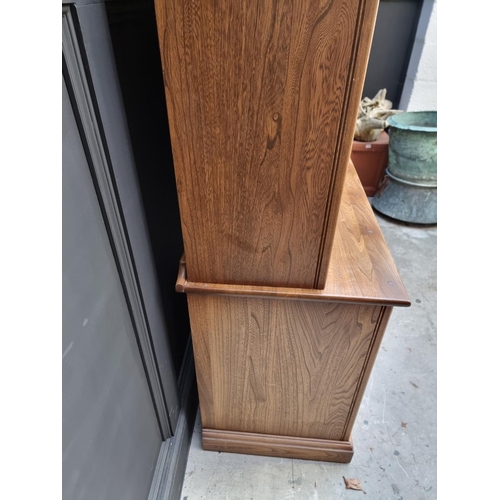 1119 - An Ercol elm bookcase, 96cm wide.