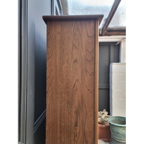 1119 - An Ercol elm bookcase, 96cm wide.