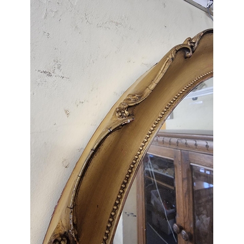 1129 - A pair of antique gilt framed oval wall mirrors, 66 x 53cm, (s.d. to mouldings).