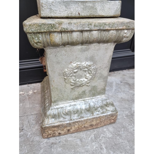 1134 - An old silver painted composition stone urn and pedestal, with ivy leaf relief decoration, 115cm hig... 