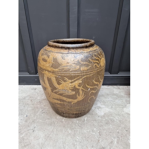 1139 - A very large Chinese glazed pottery urn, decorated with dragons, 71cm high. 