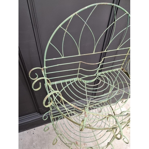 1144 - An old green painted wirework demi-lune two-tier plant stand, 110cm high x 74.5cm wide.... 