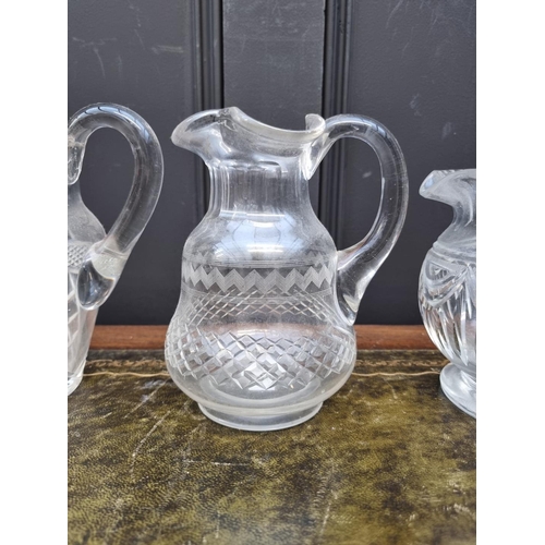 1357 - Three 19th century cut glass jugs, largest 18.5cm high. (3)