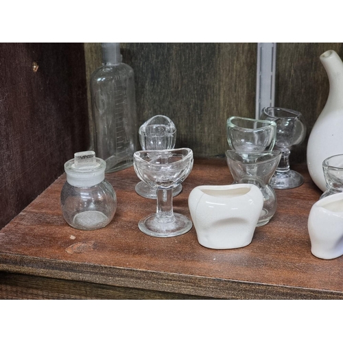 1358 - A collection of antique glass eyebaths and other medical items, to include Bristol Blue examples.... 