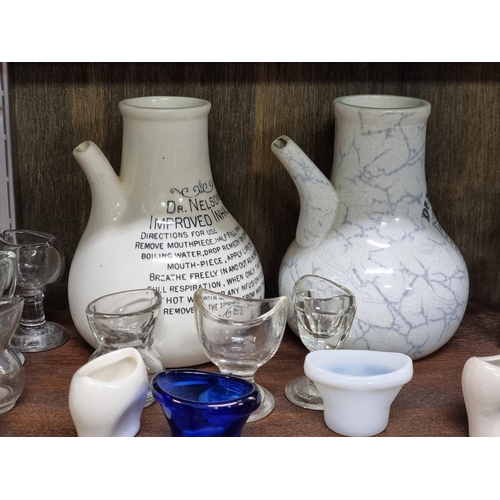 1358 - A collection of antique glass eyebaths and other medical items, to include Bristol Blue examples.... 