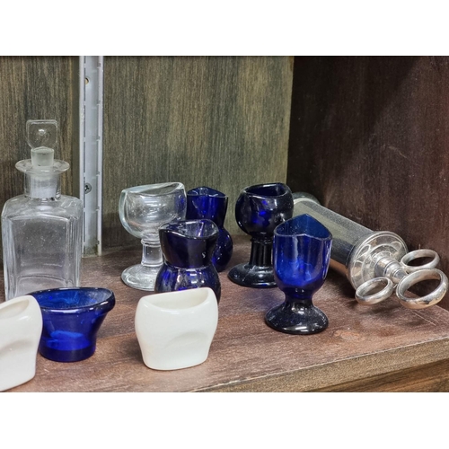 1358 - A collection of antique glass eyebaths and other medical items, to include Bristol Blue examples.... 