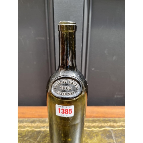 1385 - A 1903 Chateau Lafite glass wine bottle, 30cm, (lacking contents). 