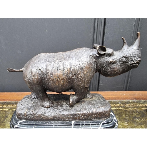 1389 - Two bronze rhinoceros, each bearing signature, on marble bases, 27cm long, (lost tip of one hor... 