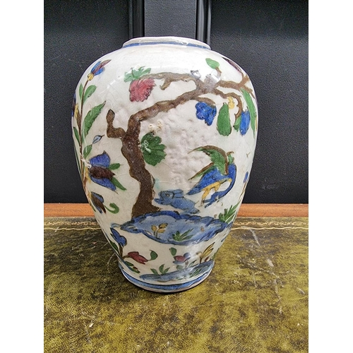 1396 - An Iznik pottery ovoid vase, painted with birds in flowering branches, 26cm high, (s.d.).... 