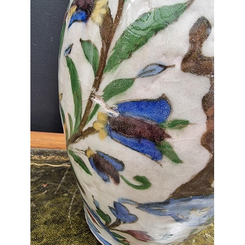 1396 - An Iznik pottery ovoid vase, painted with birds in flowering branches, 26cm high, (s.d.).... 