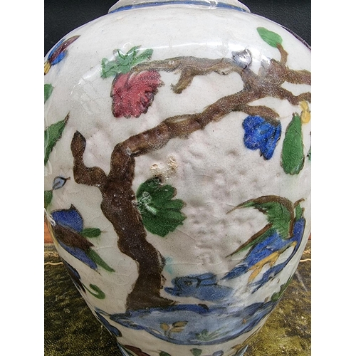 1396 - An Iznik pottery ovoid vase, painted with birds in flowering branches, 26cm high, (s.d.).... 