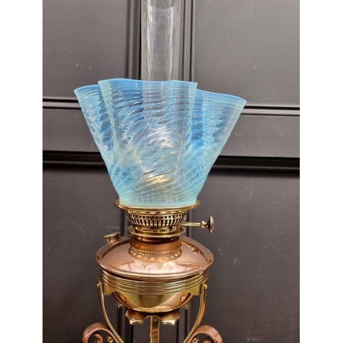 1402 - An Art Nouveau copper and brass oil lamp, in the manner of WAS Benson, with Vaseline glass shade, he... 